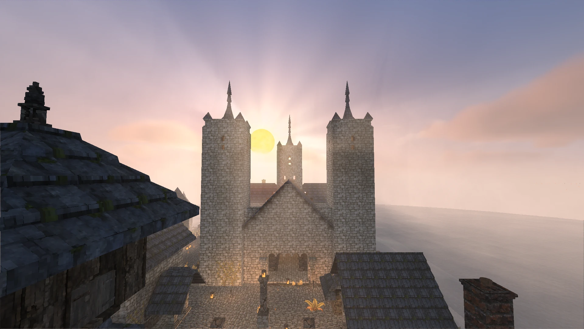 Brackenholm cathedral and its stone courtyard, seen across the rooftops