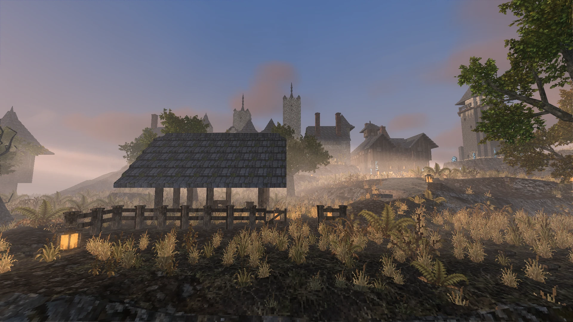 A timber shelter and fence in the workshop yard, with the town on the ridge behind